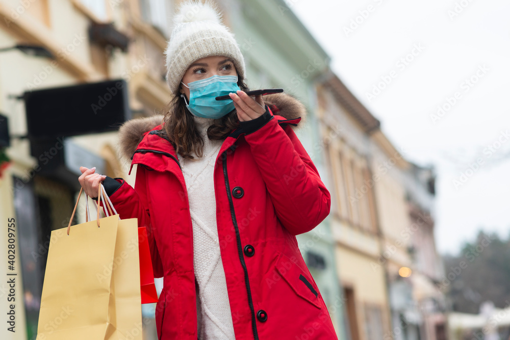 Portrait of adult woman talking on phone and wearing a mask,, coronavirus concept Portrait of adult woman talking on phone and wearing a mask,, coronavirus concept