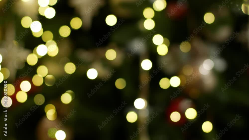 The multicolored Christmas lights of the garland on the tree sparkle brightly. Christmas tree decoration Christmas decor close-up 4K video glow. The multicolored Christmas lights of the garland on the tree sparkle brightly. Christmas tree decoration Christmas decor close-up 4K video glow.