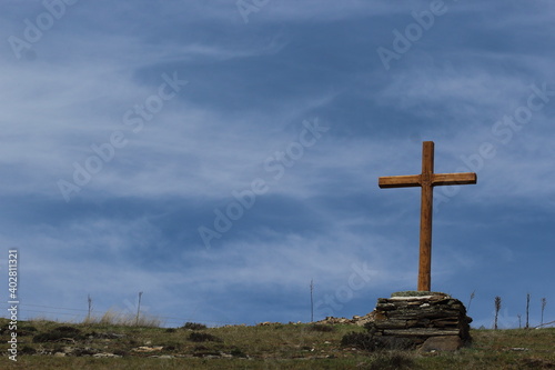 Cross with mountainous background under blue sky