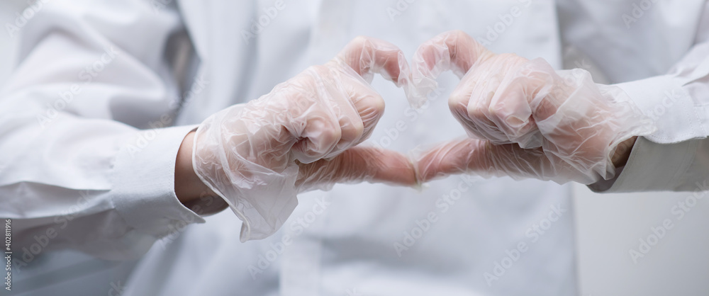 Fototapeta premium heart sign shown with gloved hands