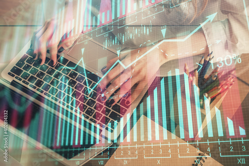 Double exposure of woman hands typing on computer and forex chart hologram drawing. Stock market invest concept.