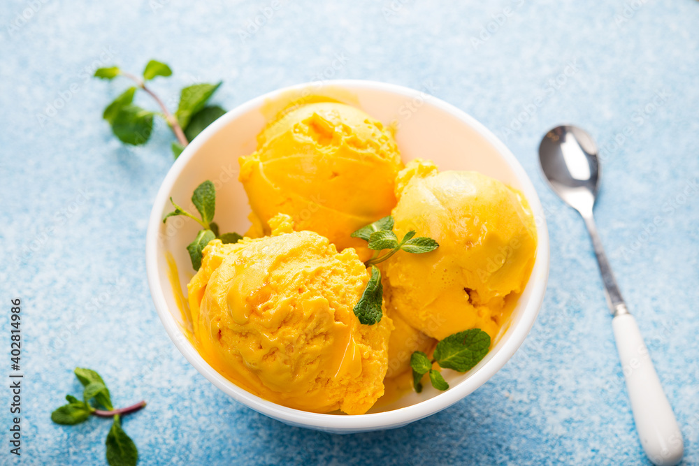 Mango ice cream, sorbet in a plate on a concrete backgroun Mango ice cream, sorbet in a plate on a concrete backgroun