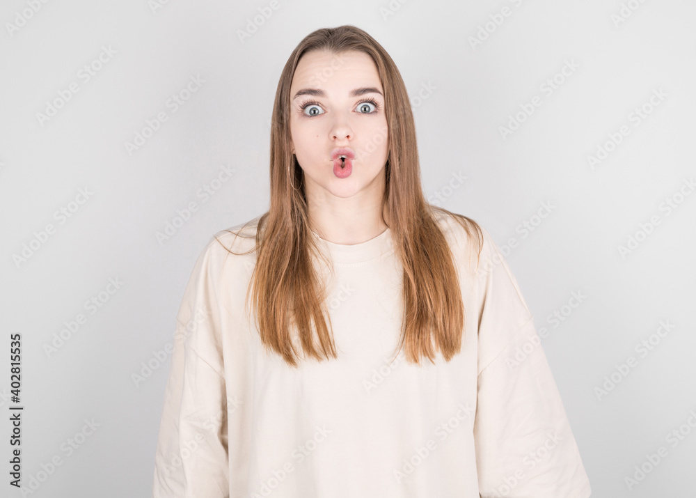 pretty brunette girl looks at the camera with a dubious and indecisive expression on her face, chasing her lips. Confused young woman posing isolated on pink wall pretty brunette girl looks at the camera with a dubious and indecisive expression on her face, chasing her lips. Confused young woman posing isolated on pink wall