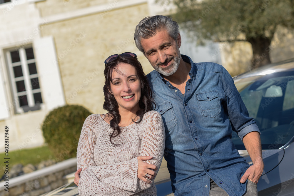 middle-aged couple satisfied with their success middle-aged couple satisfied with their success