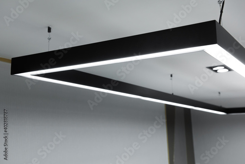 LED white cold light over workplaces. Modern office lighting.