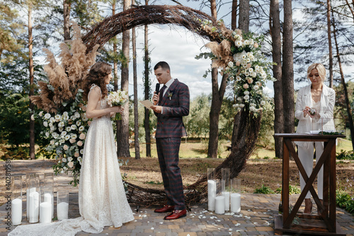 Happy groom is saying an oath during wedding ceremony. Happy marriage photo