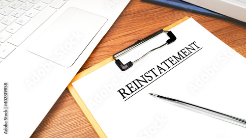 Reinstatement documents on the clipboard on the office desk. Business concept