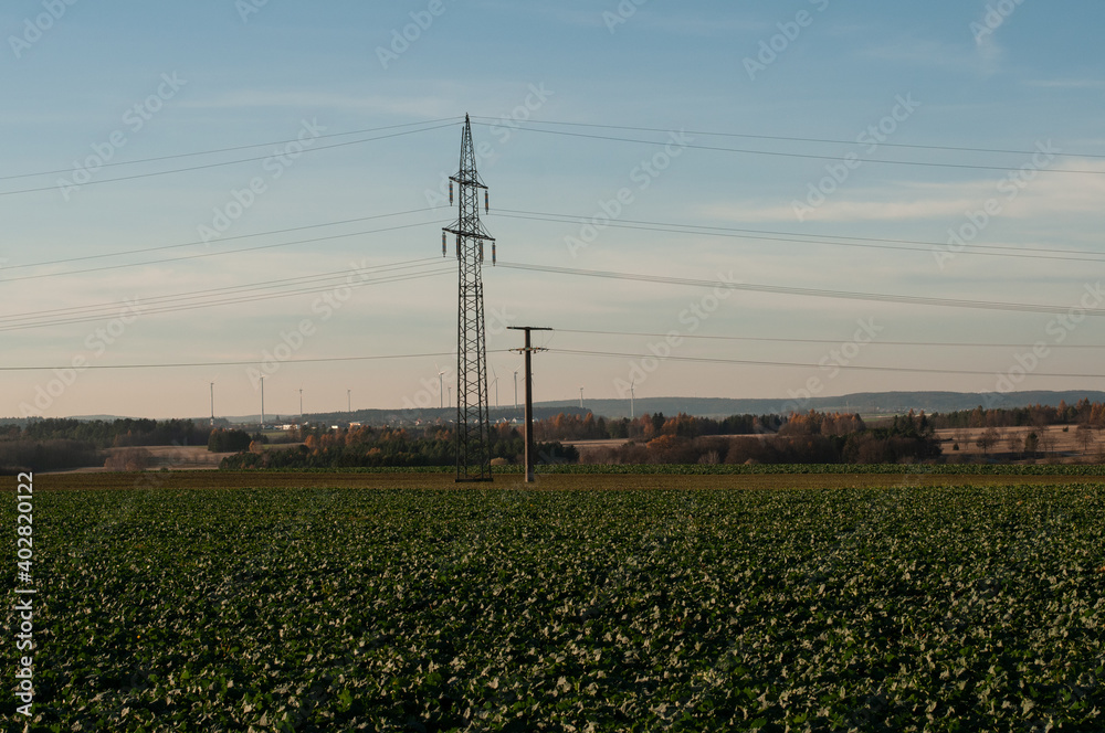 landscape in swabian alb with powerlines and windmills