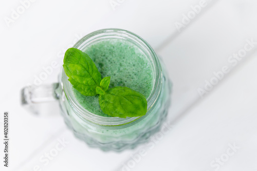 Green smoothie with fresh mint leaf. View from above. Healthy eating. Space for text.