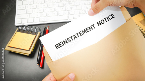 Reinstatement order (Reinstatement notice) letter in the envelope at the office desk. Business employment concept.