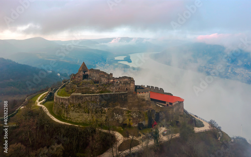 Visegrad citadet castle ruins in Danube bend Hungary. Fantastic aerial landscape in bad weather. Foggy, cloudly sunrise