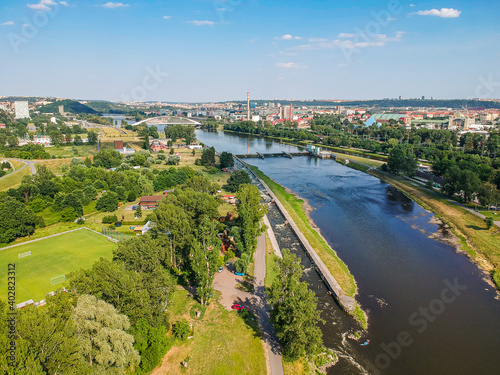 Moldau river in Troja area with architectonic bridge in background