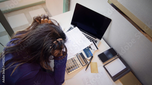 Photos Selective focus of woman headache and stressed with debts of bill which she is