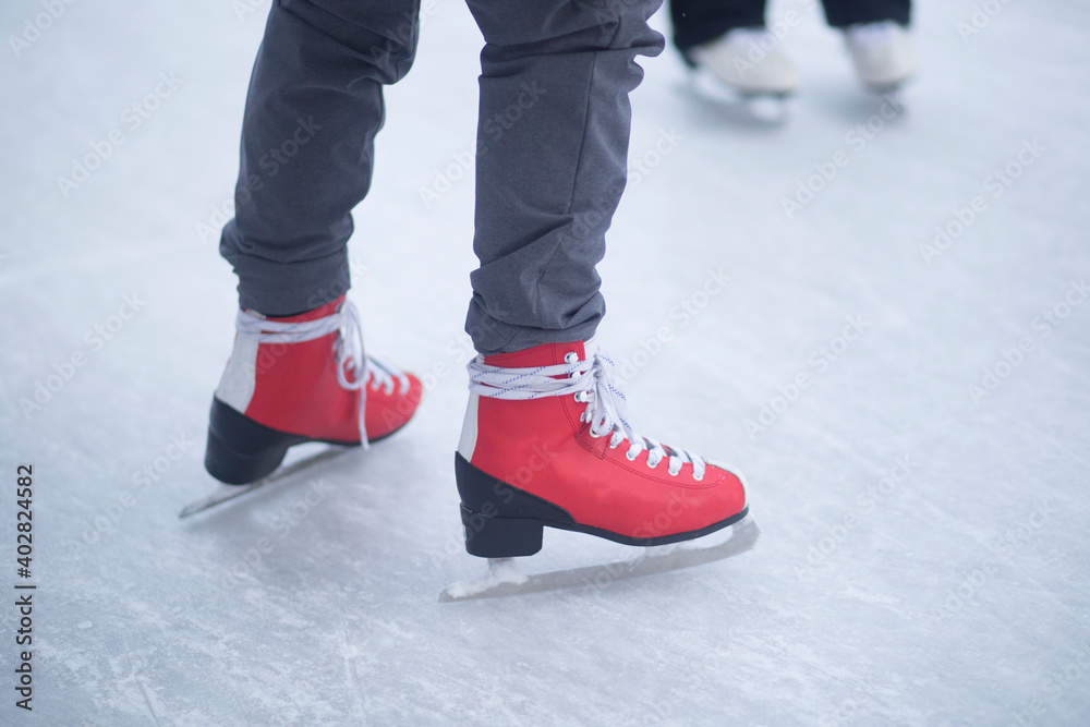 People skate in the winter in the cold on the ice rink. People skate in the winter in the cold on the ice rink.