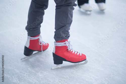 People skate in the winter in the cold on the ice rink.
