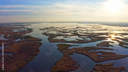 Irresistible floods on the Samara River on the Dnieper in Ukraine in the evening warm bright light. Aerial UHD 4K drone realtime video, shot in 10bit HLG and colorized