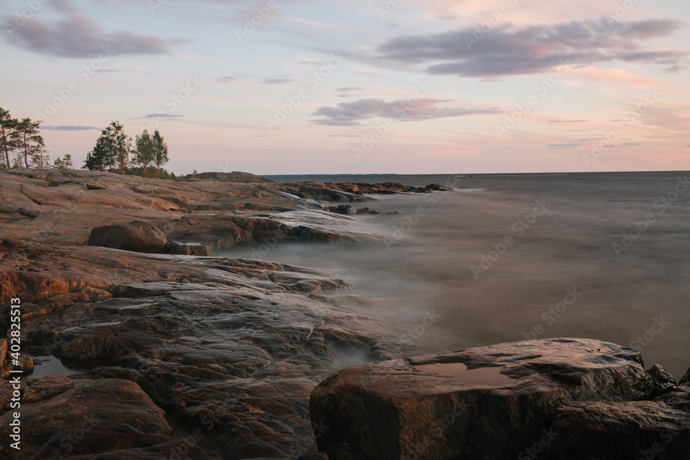 Long exposure sunset shot of rocky shoreline in Finland
