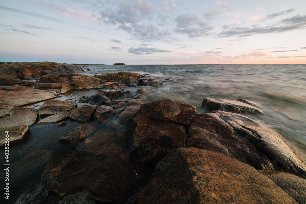 Scenic long exposure sunset over the rocky shore of Faboda, Finland Scenic long exposure sunset over the rocky shore of Faboda, Finland