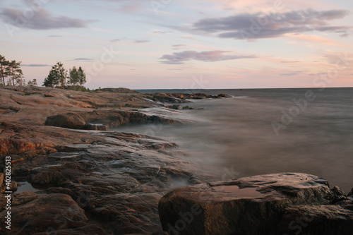 Long exposure sunset shot of rocky shoreline in Finland