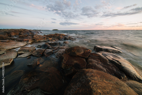 Scenic long exposure sunset over the rocky shore of Faboda, Finland
