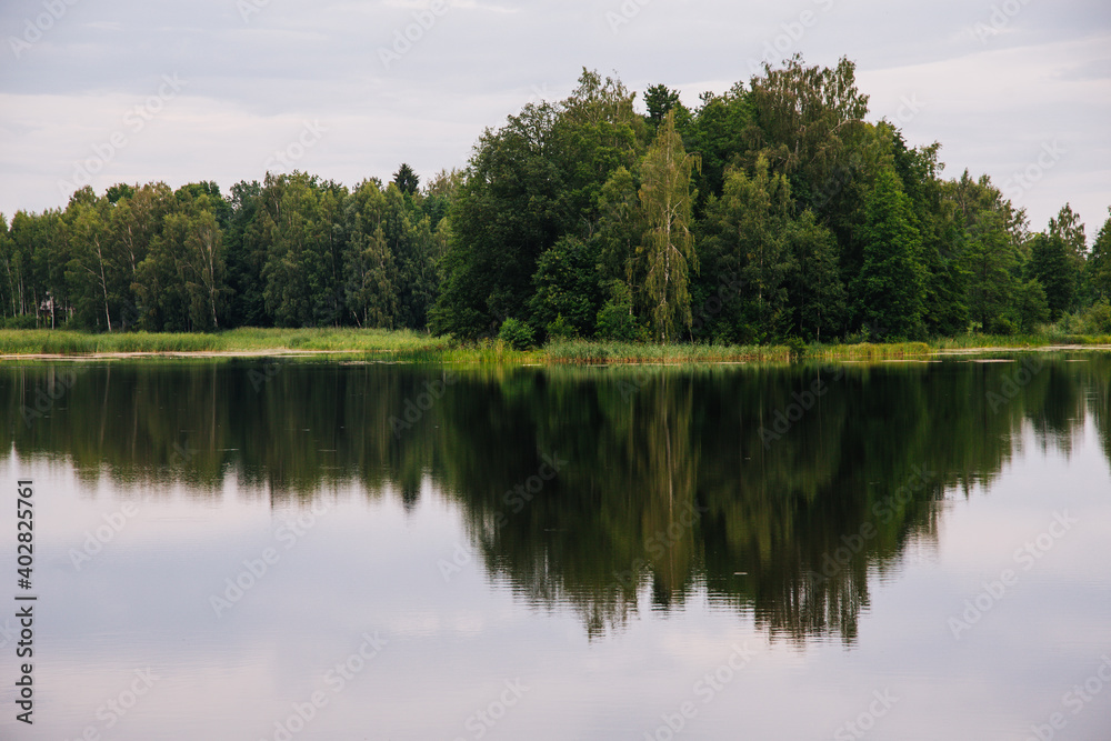 Lake in forest with reflection of trees in water