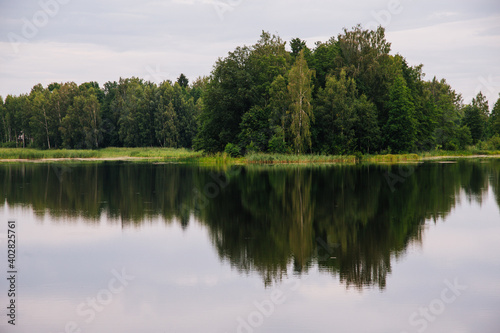 Fototapeta Naklejka Na Ścianę i Meble -  Lake in forest with reflection of trees in water