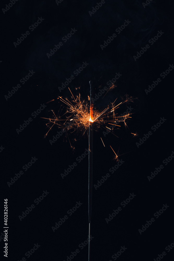 New Year Christmas sparkler on dark background . Close up view