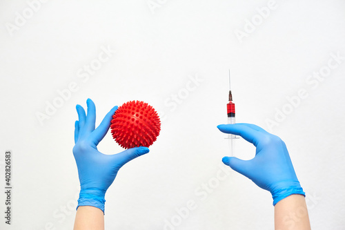 coronavirus vaccine, vaccination of the population against the disease, fighting the epidemic, hands in medical gloves holding a syringe with medicine