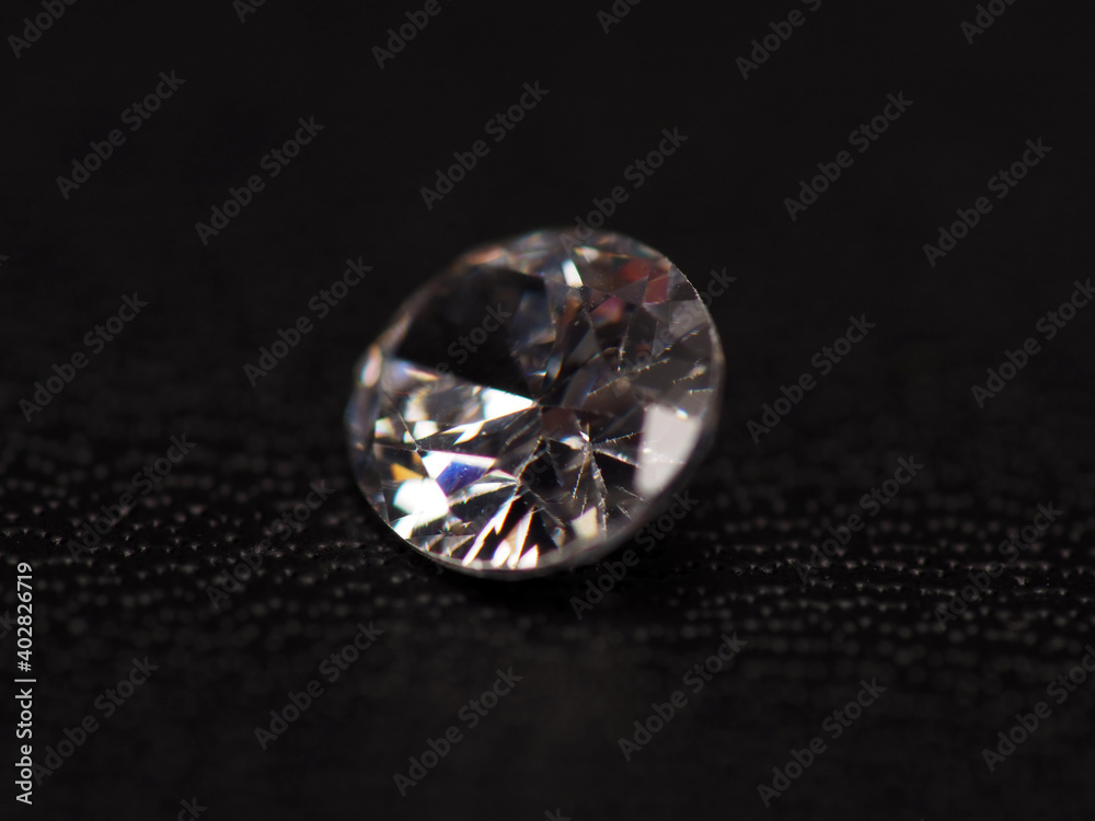 Close up shoot of group of sparkling diamonds, shoot on black leather as background
