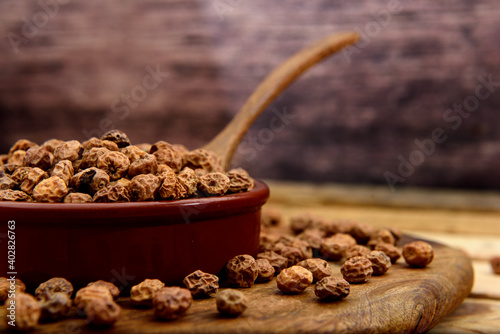 Tiger nuts in a ceramic pot on a wooden table