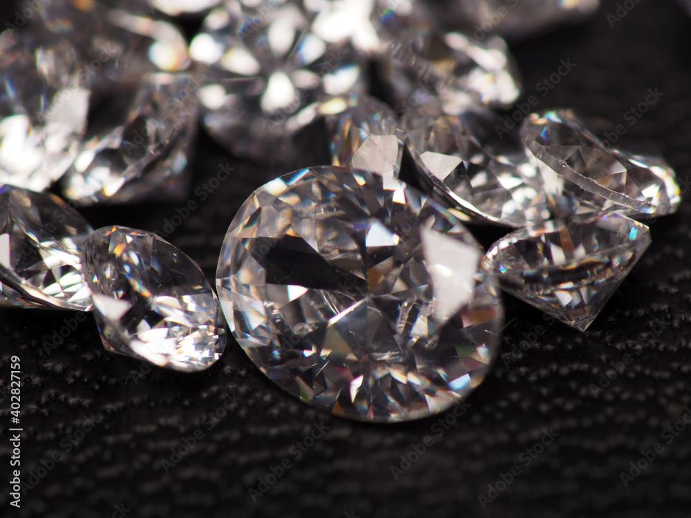Close up shoot of group of sparkling diamonds, shoot on black leather as background Close up shoot of group of sparkling diamonds, shoot on black leather as background