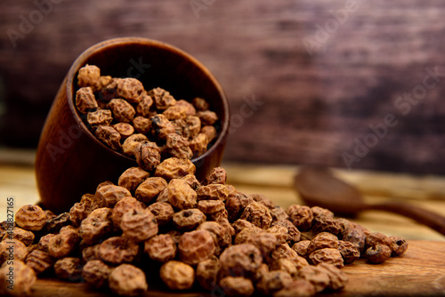 Tiger nuts falling out of a wooden pot