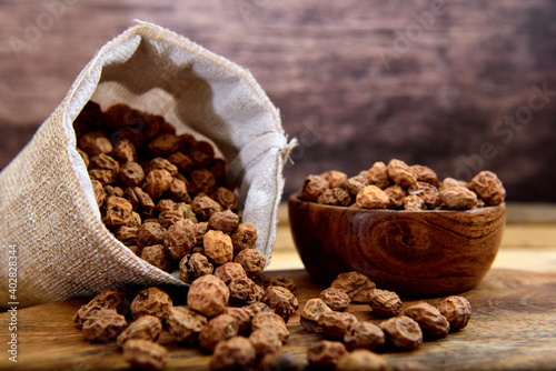 Organic Tiger nuts on a wooden table photo
