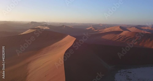 4K aerial drone footage of famous endless sand sea and Sossusvlei Namib Desert scenic red sand dunes on sunny morning in Namib-Naukluft Park in Namibia, southern Africa