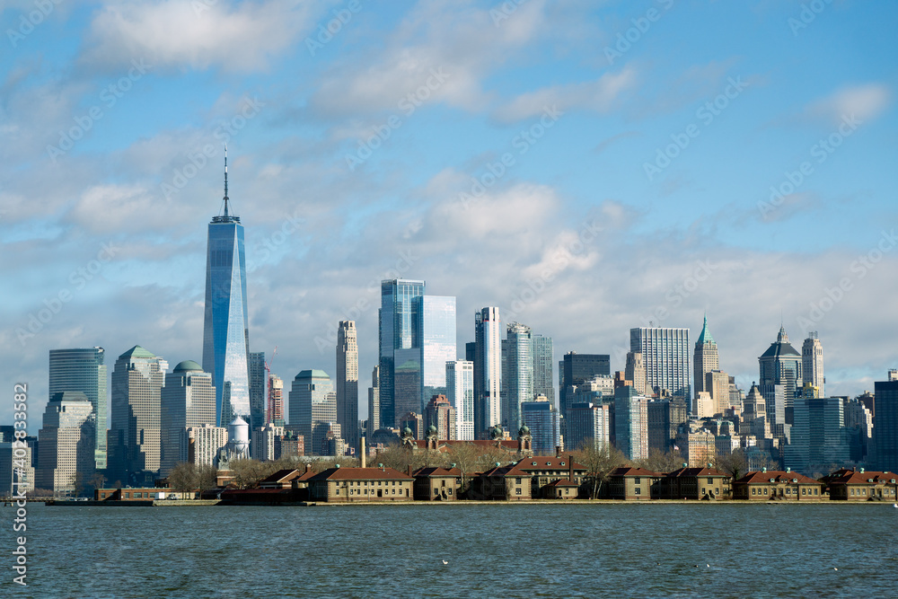 New York, NY - USA - Jan 2, 2021: Landscape view of lower Manhattan skyline with Ellis Island in the foreground. New York, NY - USA - Jan 2, 2021: Landscape view of lower Manhattan skyline with Ellis Island in the foreground.