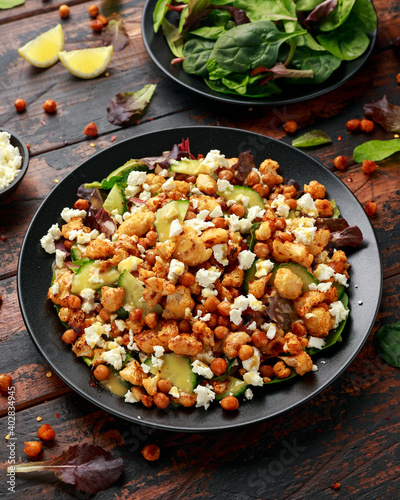Roasted Cauliflower salad with chickpea, cucumber, greens and feta cheese. healthy food