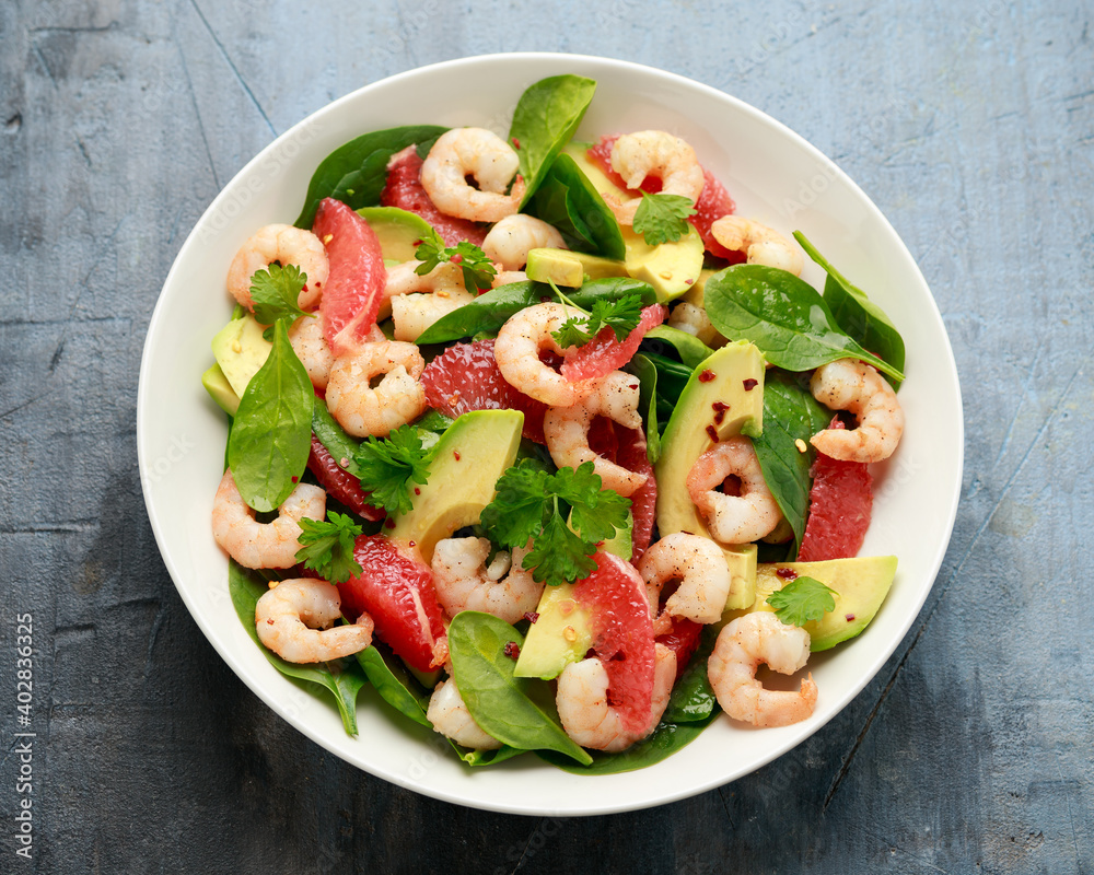 Fresh Avocado Grapefruit shrimp salad in white plate Fresh Avocado Grapefruit shrimp salad in white plate