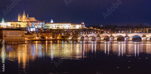 Amazing panoramic view on Prague Castle, St Vitus Cathedral and Charles Bridge with reflection of lights in Vltava river. Old town, Czech Republic © vladim_ka