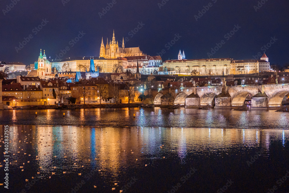 Amazing panoramic view on Prague Castle, St Vitus Cathedral and Charles Bridge with reflection of lights in Vltava river. Old town, Czech Republic