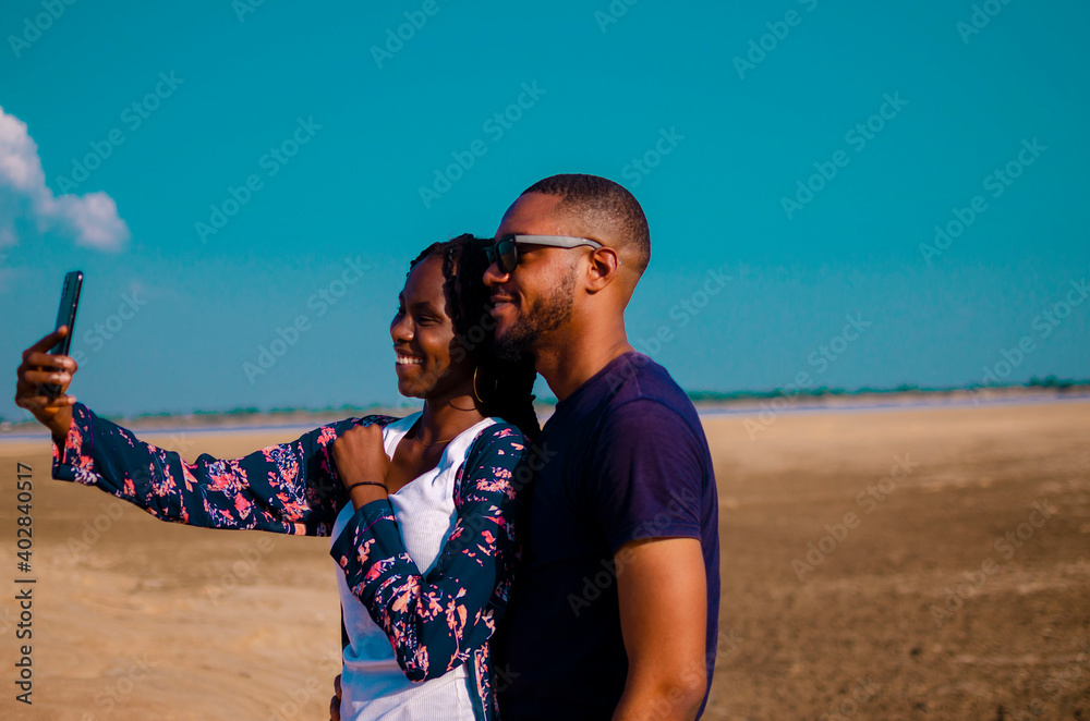 two young cute african student on a vacation taking selfie with their cellphone