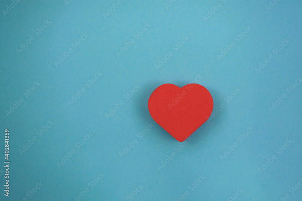 one red heart on a blue background