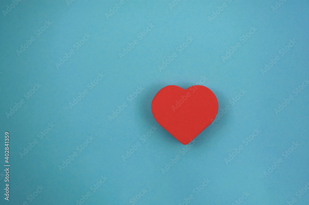 Fototapeta premium one red heart on a blue background