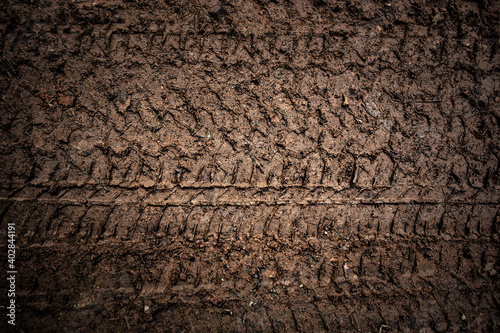Tyre track on dirt sand or mud, Picture in retro or grunge tone. Car drive on sand. off road track. Track on grass field. Track in farm.