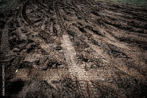 Tyre track on dirt sand or mud, Picture in retro or grunge tone. Car drive on sand. off road track. Track on grass field. Track in farm.