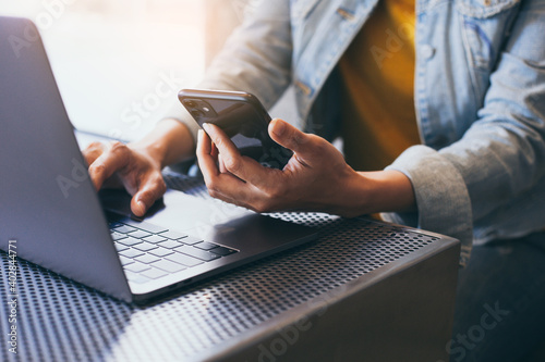 work using texting cell phone typing computer.chatting on mobile,laptop contact us at workplace Thinking investment plan Investor.searching information internet.connecting people concept