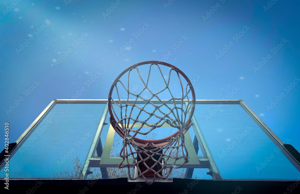 low angle view of basketball hoop and net against blue sky clear background. low angle view of basketball hoop and net against blue sky clear background.