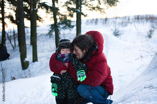 young happy father with his son little cute boy outside in winter park, lifestyle people concept