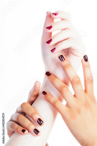 two different nathion manicured hands on white isolated, african with caucasian