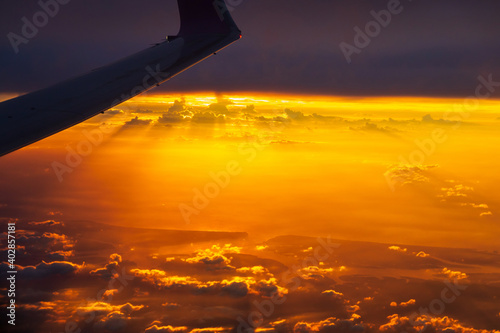 Dramatic sunset sky with clouds. Skyscraper background view seen from the plane. © pjjaruwan