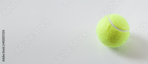  Tennis ball on the grey background. Space for your text © andranik123